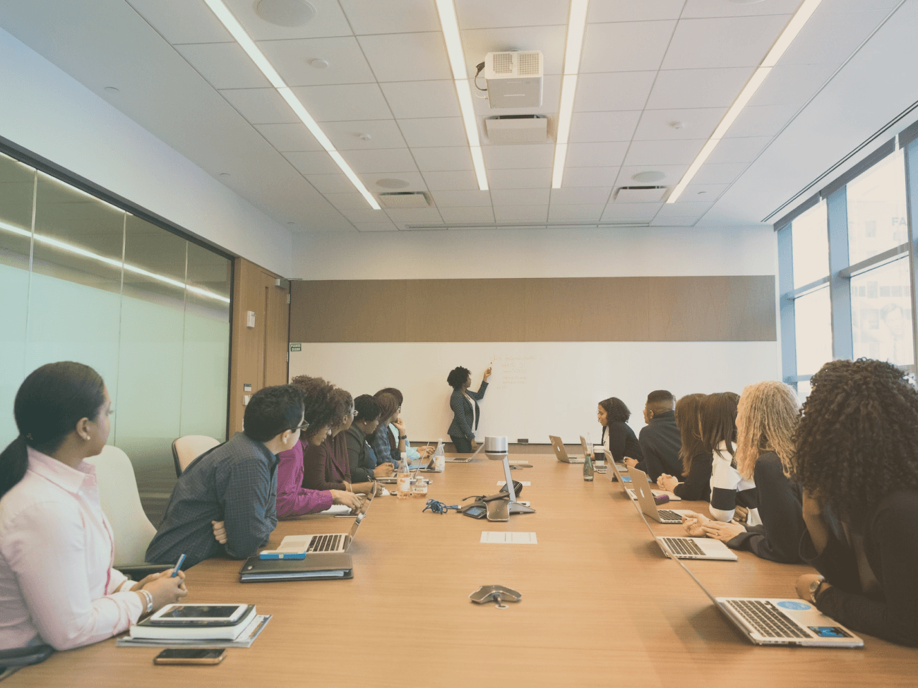 people sitting at desk in meeting